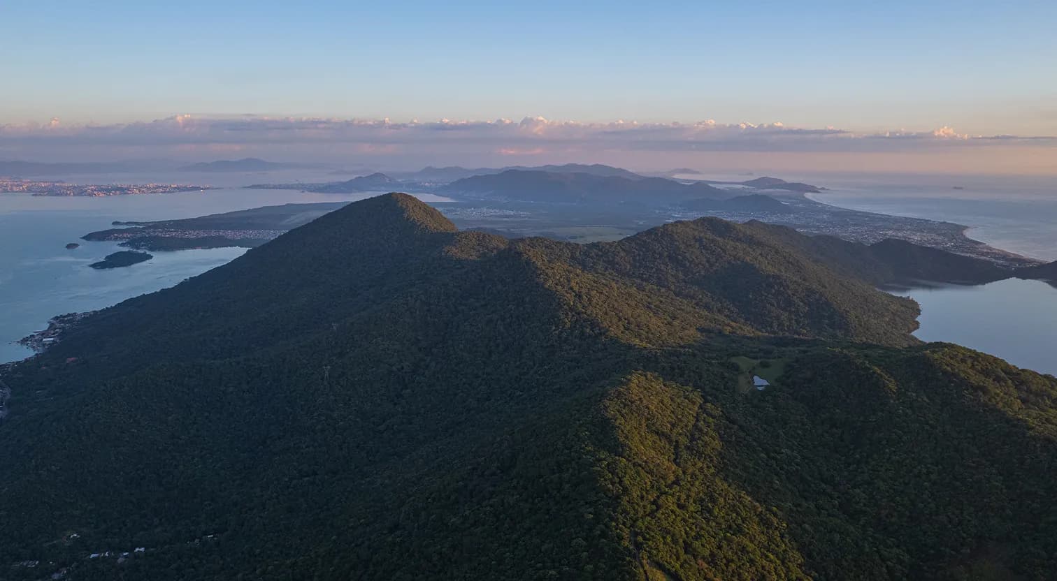 Forested mountains meeting the sea at dawn in southern Brazil