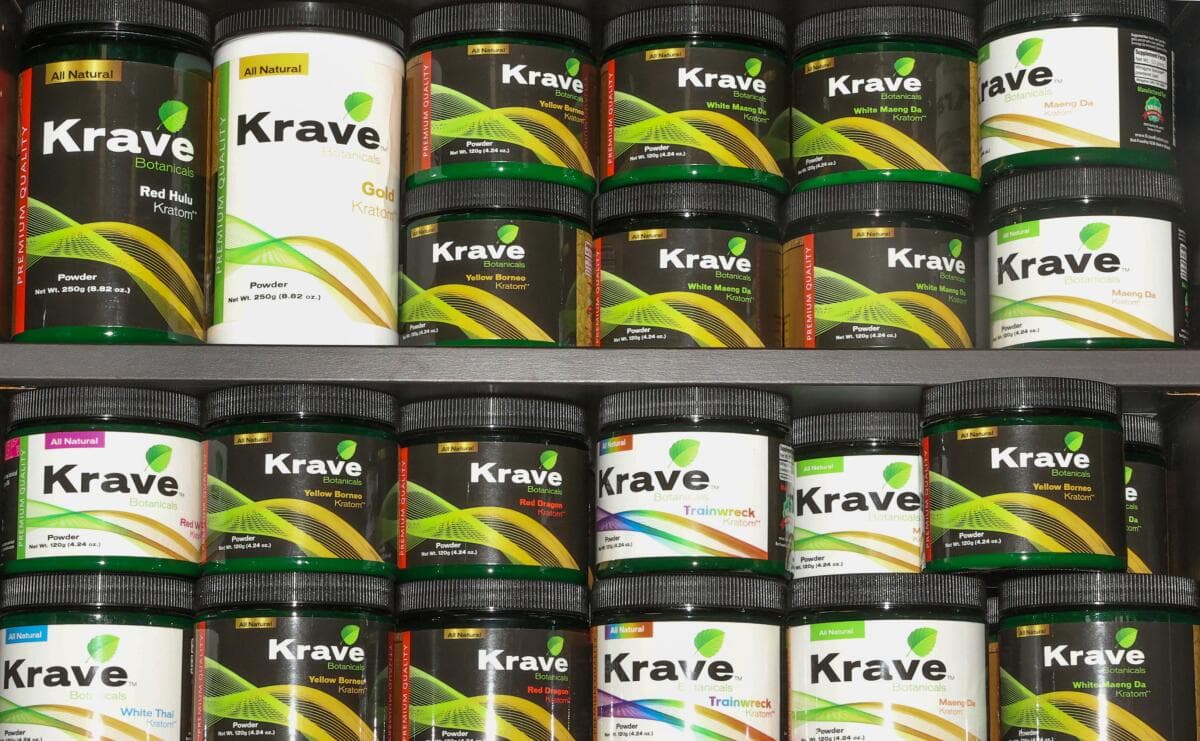 Shelves of Krave Botanicals kratom powder jars