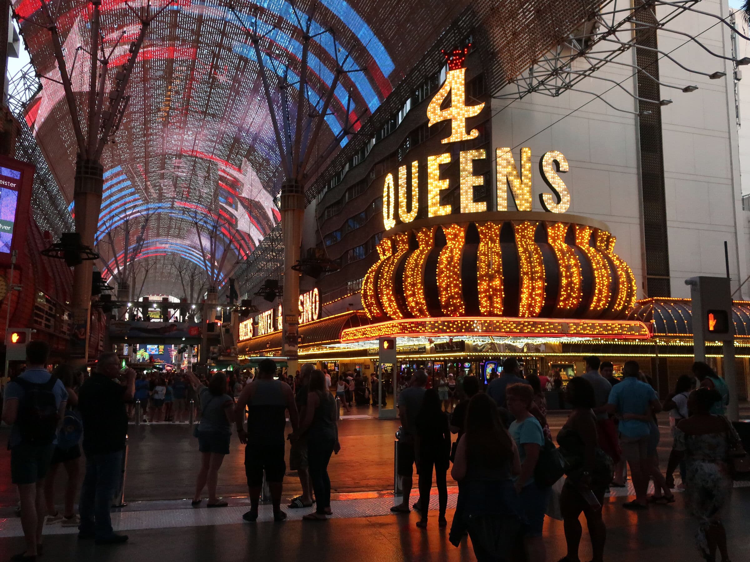 Casino neon signs glowing over a crowd at night